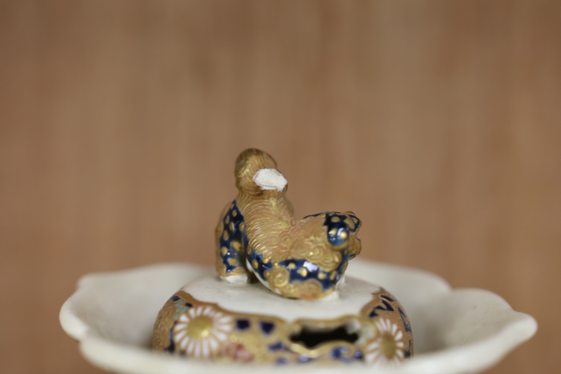 A late 19th century Japanese Satsuma ‘hundred antiques’ gosu blue pot pourri vase and three later items of Satsuma, including a bowl and cover a bowl on stand, a box and cover, tallest 18.5cm high. Condition - vase cover